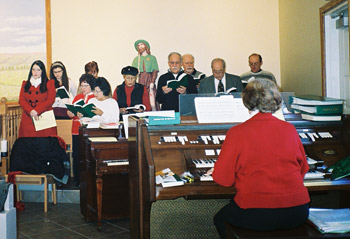 Celeste Jones accompanies the choir on the organ; she also directs the singing.
